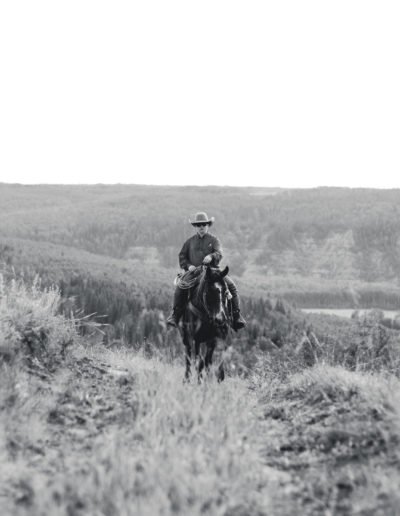 youth riding horse up hill